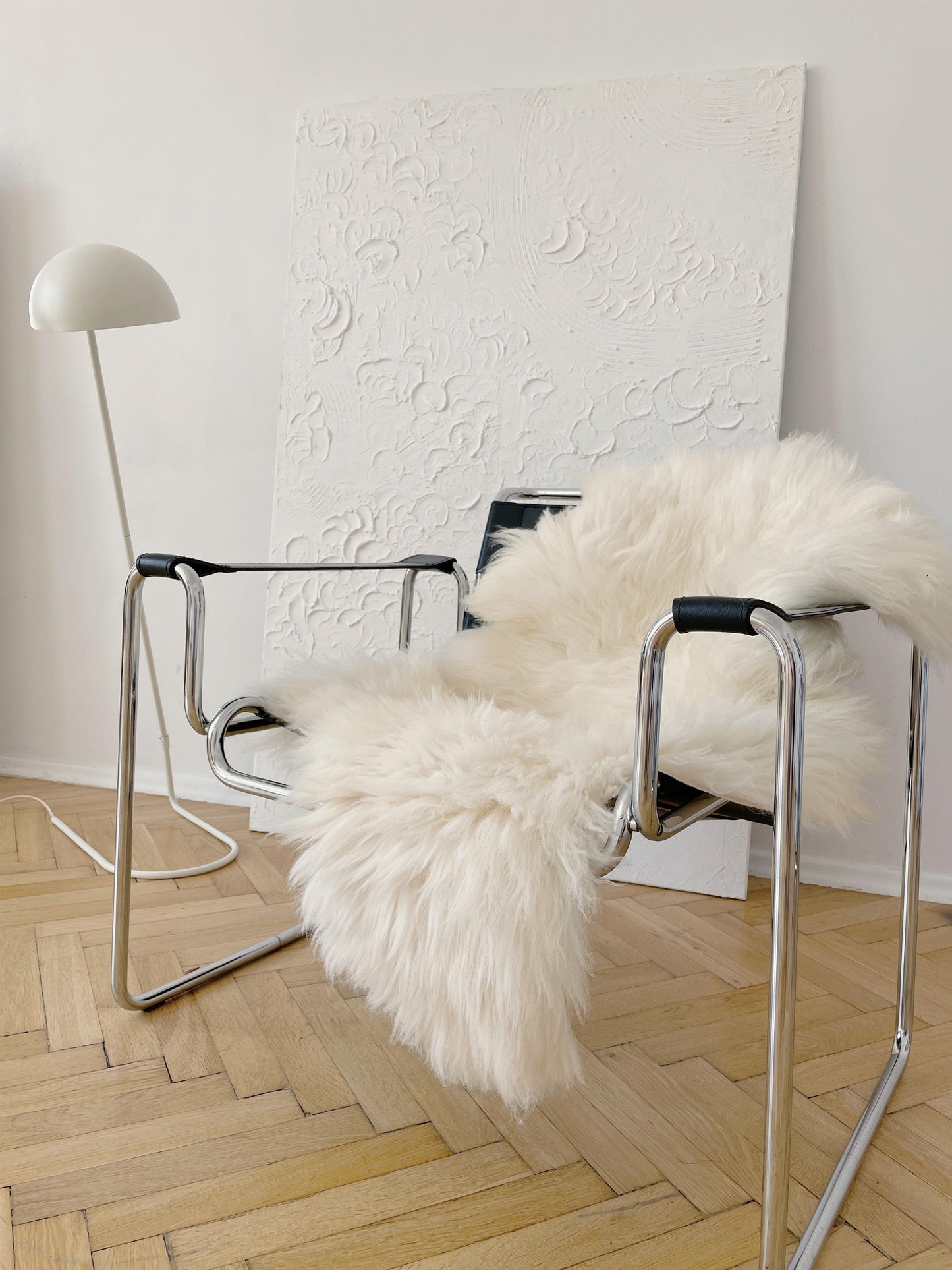 A white Natural Sheepskin Rug for Pet from Mellow Pet Store on a chair in an eco-luxury room.