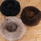 Three Mellow Pet Store Round Natural Sheepskin Pet Beds on a wooden floor.