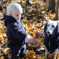 A little boy and a Mellow Pet Store Woolen Dog Vest - Charcoal in the natural woods.