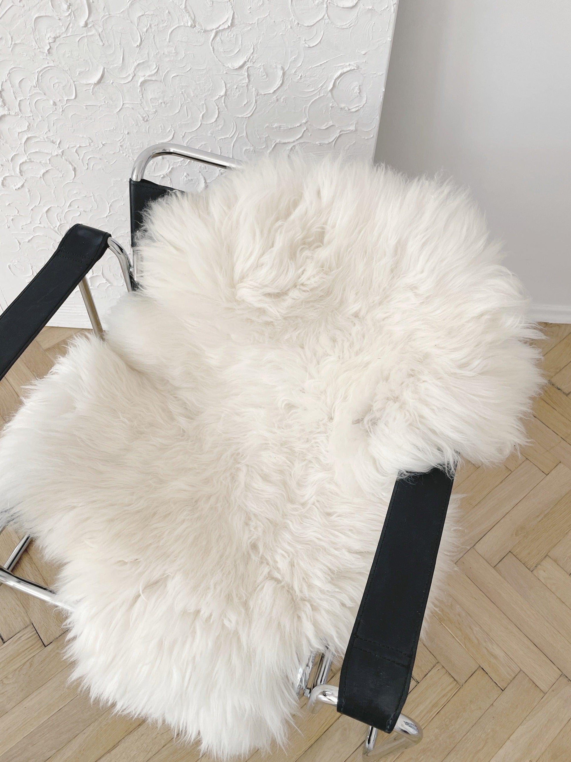 A chair with a soft Mellow Pet Store Natural Sheepskin Rug for Pet on it.